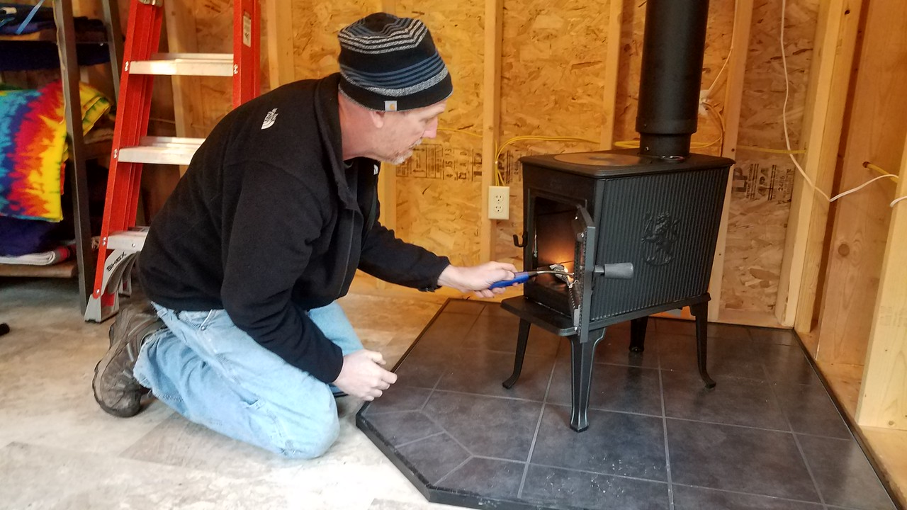 Kevin lighting the stove in his studio